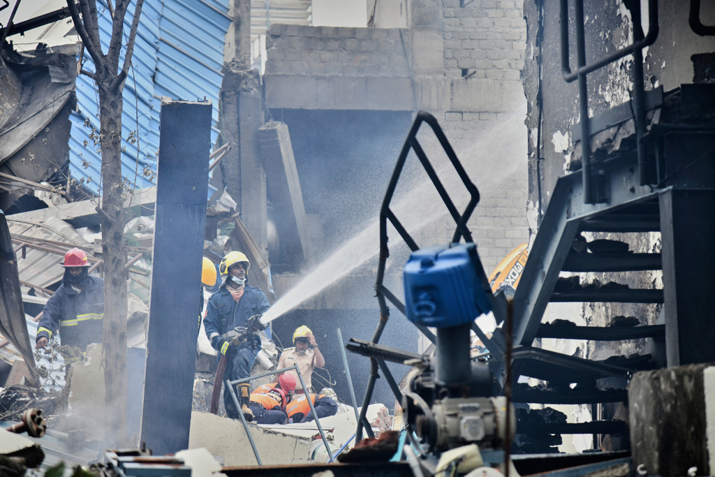 Firefighters extinguish a fire after an explosion at a pharmaceutical factory in an industrial area in Sangareddy some 50 kilometers (31 miles) from Hyderabad, India, Monday, June 30, 2025.