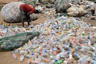 A scavenger sorts out plastic waste at a dumpsite on the outskirts of Lagos, Nigeria, Monday, Aug 11, 2025.