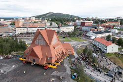 On a specially designed trolley with 224 wheels, Kiruna Church is moved for relocation at a speed of half a kilometer per hour, in Kiruna, Sweden, Tuesday Aug. 19, 2025.