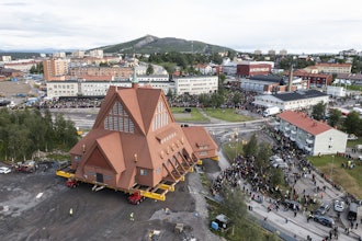 On a specially designed trolley with 224 wheels, Kiruna Church is moved for relocation at a speed of half a kilometer per hour, in Kiruna, Sweden, Tuesday Aug. 19, 2025.