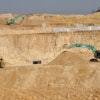 Workers use machinery to dig at a rare earth mine in Ganxian county in central China's Jiangxi province on Dec. 30, 2010.