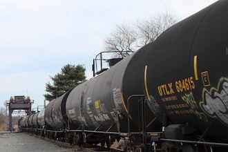 This image provided by the Howard Center for Investigative Journalism shows a train carrying tank cars, some containing hazardous materials, traveling across a railroad bridge in Paulsboro, N.J., on March 20, 2025, that was the site of a derailment and spill of toxic vinyl chloride in 2012.