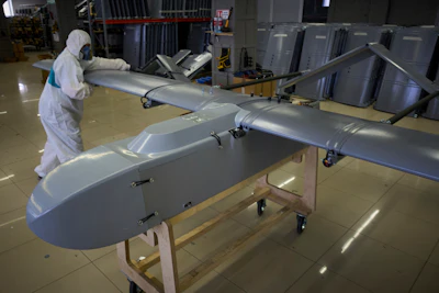A worker inspects a combat drone at Fire Point's secret factory in Ukraine on Monday, Aug. 18, 2025.