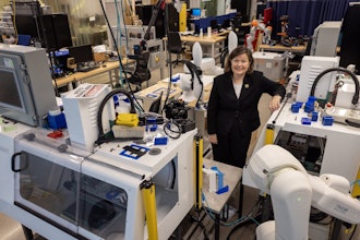 Dawn Tilbury in the SMART 4.0 Lab in the Ford Robotics Building at U-M. This equipment will help test digital twin software developed through the new center.