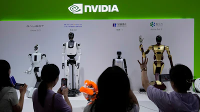 Visitors give commands to a robot at Nvidia's booth during the 3rd China International Supply Chain Expo at the China International Exhibition Center, in Beijing, July 18, 2025.