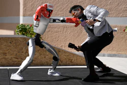 The Unitree G1 robot plays boxing with Aadeel Akhtar CEO and Founder of Psyonic at the first International Humanoid Olympiad at the Olympic Academy, in ancient Olympia, Greece, Monday, Sept. 1, 2025.