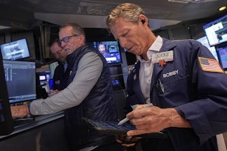 Trader Robert Charmak, right, and specialist Glenn Carell, center, work on the floor of the New York Stock Exchange, Sept. 10, 2025.