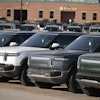 A long line of unsold 2024 R1S electric utility vehicles sits at a Rivian service center Nov. 26, 2024, in east Denver.