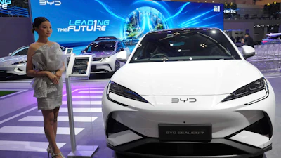 A model stands near a Sealion 7, an electric vehicle from Chinese automaker BYD, during the Gaikindo Indonesia International Auto Show in Tangerang, Indonesia, Wednesday, July 23, 2025.