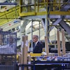 Prime Minister Mark Carney walks through a manufacturing facility ahead of a press conference in Mississauga, Ont., on Friday, Sept. 5, 2025.
