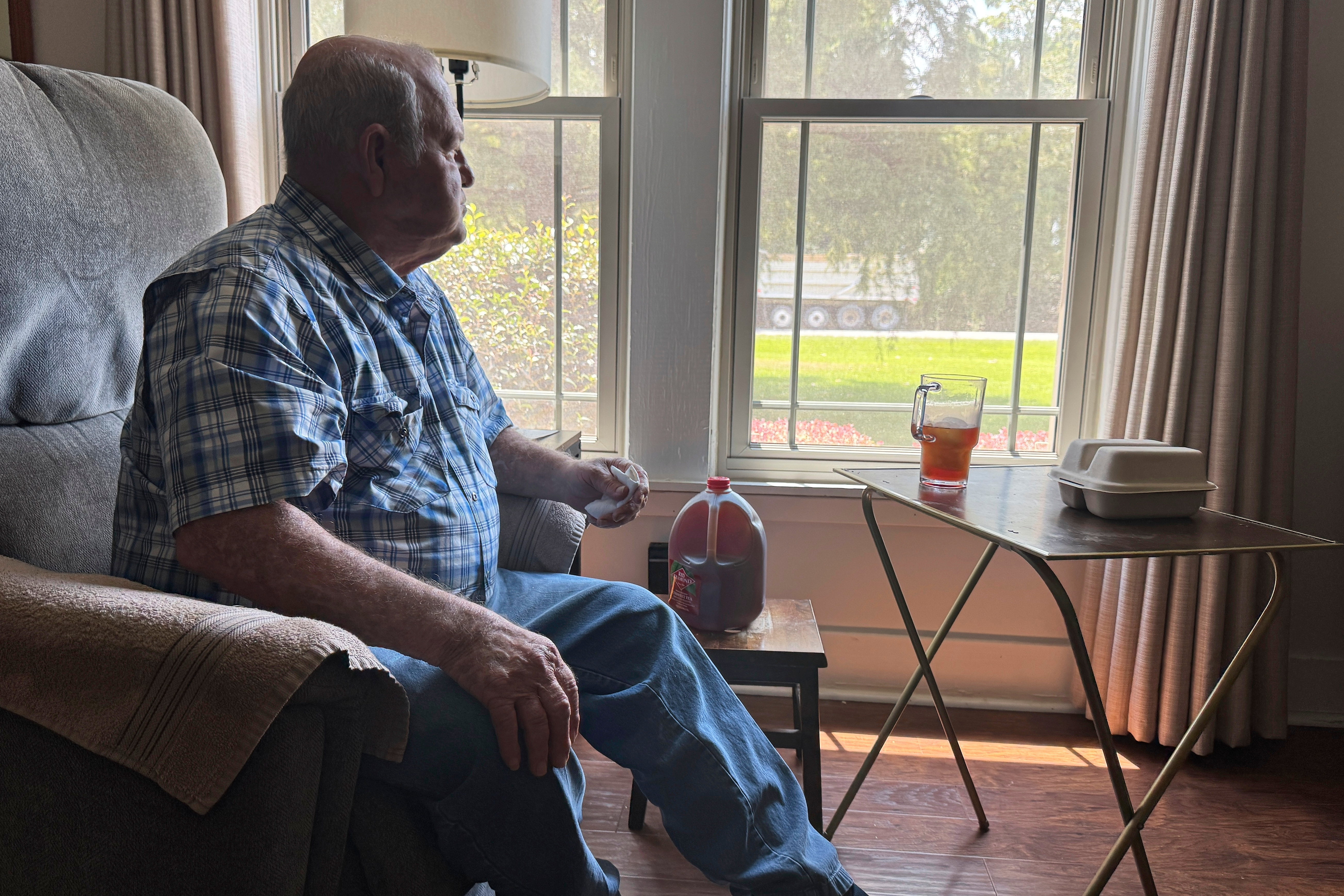 Buddy McCartney watches hundreds of trucks pass by his home in Holly Ridge, La., on their way to what will become Meta's largest data center, Monday, Aug. 18, 2025.