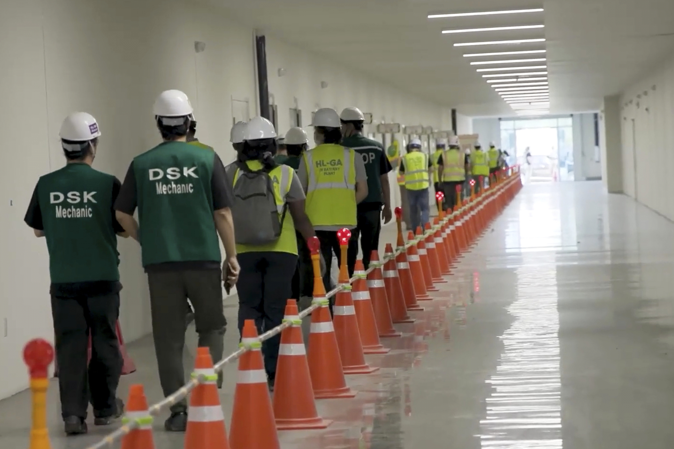 This image from video provided by U.S. Immigration and Customs Enforcement via DVIDS shows manufacturing plant employees being escorted outside the Hyundai Motor Group&rsquo;s electric vehicle plant, Thursday, Sept. 4, 2025, in Ellabell, Ga.