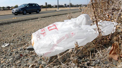 A plastic shopping bag liters the roadside in Sacramento, Calif, Friday, Oct. 25, 2013.