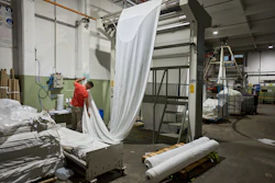 German Flores measures fabric at the Galfione Group textile factory in Buenos Aires, Argentina, Monday, Oct. 13, 2025.