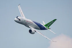 Attendees pass by a model of the Chinese-made C919 passenger jet at the Sinochem booth during the China International Supply Chain Expo in Beijing, Nov. 27, 2024.