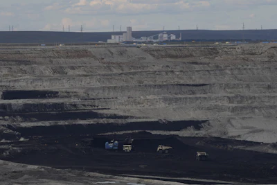 Traditional manned trucks operate in the Huaneng Yimin open-pit coal mine in Hulunbuir in northern China's Inner Mongolia province China, Monday, Sept. 15, 2025.