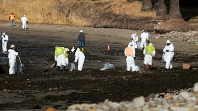 Clean up crews remove oil-laden sand on the beach at Refugio State Beach, site of an oil spill, north of Goleta, Calif., May 20, 2015.