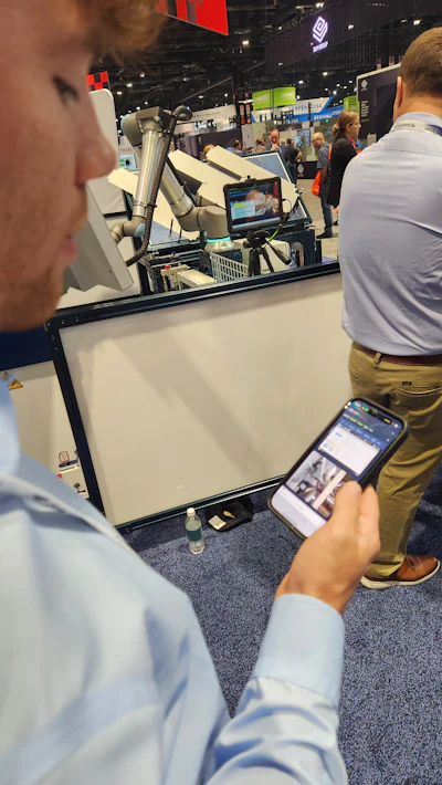 Troubleshooting from the FABTECH floor in Chicago: Automation engineer at Mid Atlantic Machinery, Jim Eberle, uses the Olis app to help a customer in Easton, MD, experiencing an issue where the robot was colliding with the punch tooling. Eberle pulled up the Olis video feed and saw that the end effector was wobbling a bit at higher speeds and catching the punch. He fixed the issue remotely and the customer was up and running again immediately.
