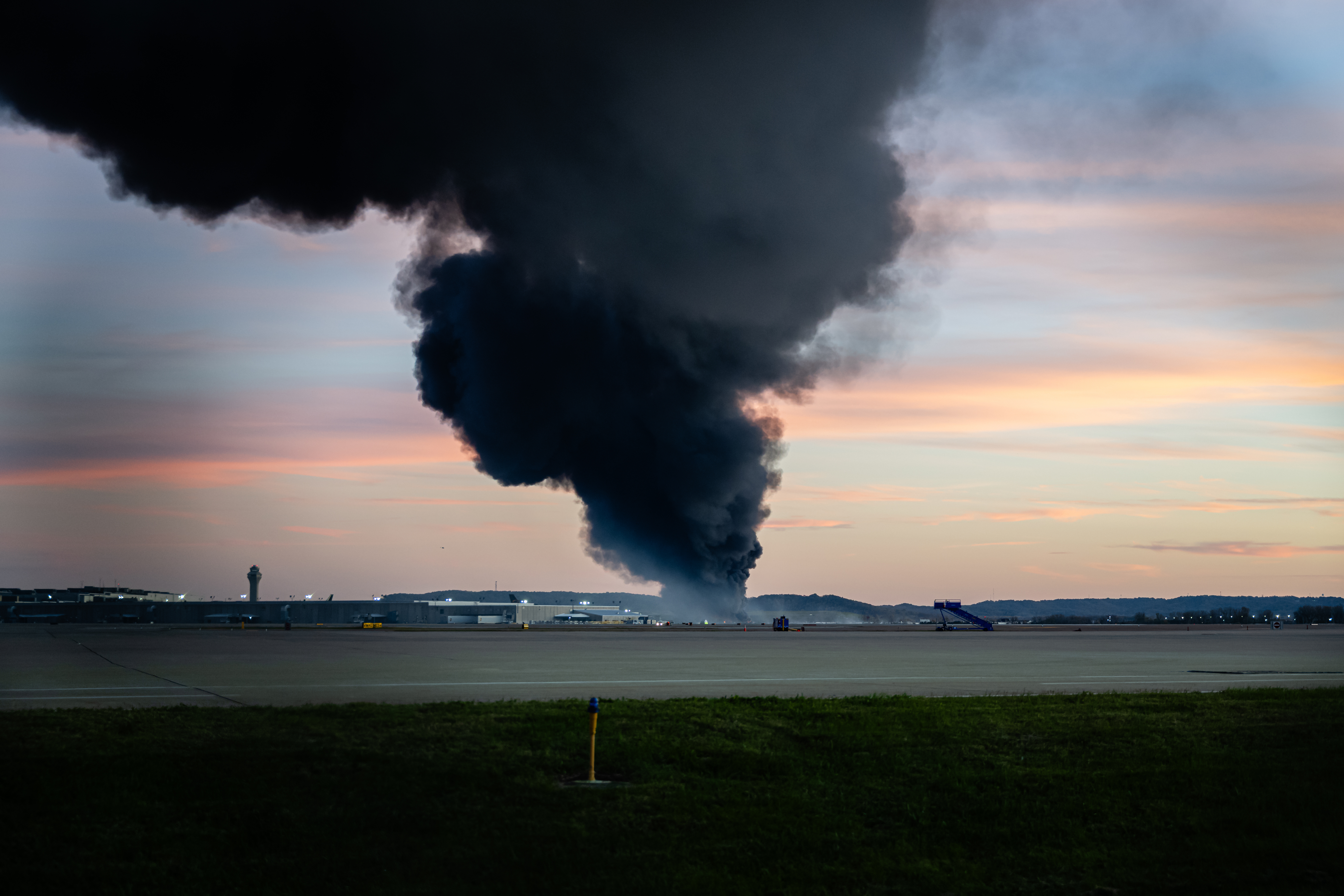 A plume of smoke rises from the site of a UPS cargo plane crash at Louisville Muhammad Ali International Airport on Tuesday, Nov. 4, 2025, in Louisville, Ky.