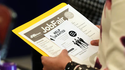 A job seeker waits to talk to a recruiter at a job fair, Aug. 28, 2025, in Sunrise, Fla.