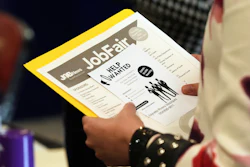 A job seeker waits to talk to a recruiter at a job fair, Aug. 28, 2025, in Sunrise, Fla.