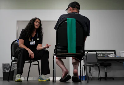 Lisa Emery, director of the New River Health Association Black Lung Clinic, right, works a patient with black lung disease Tuesday, Sept. 23, 2025, in Oak Hill, W.Va.