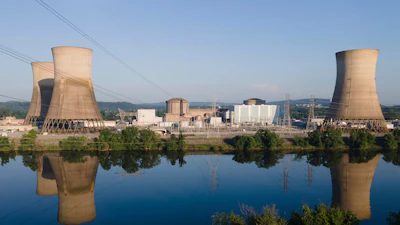 At Constellation's nuclear power plant on Three Mile Island, called the Crane Clean Energy Center, near Middletown, Pa., the cooling towers are reflected in the Susquehanna River at sunrise, June 25, 2025.