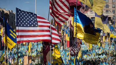 US and Ukrainian national flags wave to commemorate American volunteers, who were killed in battles with Russian troops defending Ukraine, their names are on flags, at the improvised war memorial in Independence square in Kyiv, Ukraine, Sept. 27, 2024.