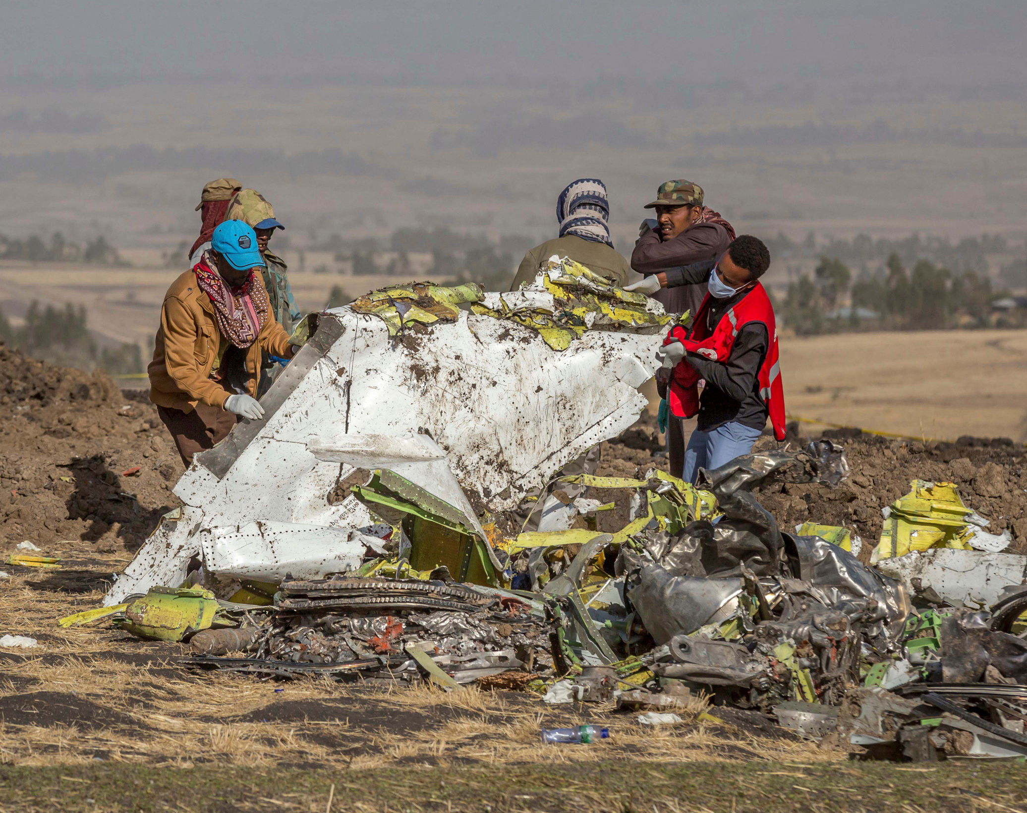 In this March 11, 2019, file photo, rescuers work at the scene of an Ethiopian Airlines flight crash near Bishoftu, Ethiopia. Pilot Bernd Kai von Hoesslin pleaded with his bosses for more training on the Boeing Max, just weeks before the Ethiopian Airline's jet crashed, killing everyone on board.