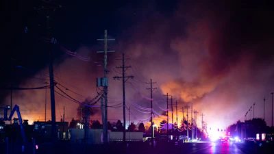 A plume of smoke rises from the site of a UPS cargo plane crash at Louisville Muhammad Ali International Airport on Tuesday, Nov. 4, 2025, in Louisville, Ky.