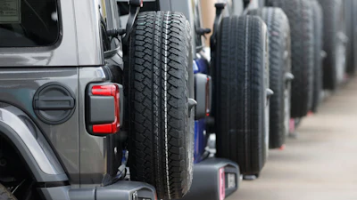 Spare tires are seen on a long row of unsold 2020 Wranglers sit at a Jeep dealership in Englewood, Colo., on April 26, 2020.