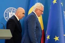Romanian Prime Minister Ilie Bolojan, left, and Germany's Rheinmetall AG CEO Armin Papperger leave after a joint press statement in Bucharest, Romania, Monday, Nov. 3, 2025, following the signing a partnership to build an ammunition powder factory.