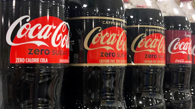 Bottles of Coca-Cola products sit on a shelf at a store in Dania Beach, Fla., Oct. 20, 2020.