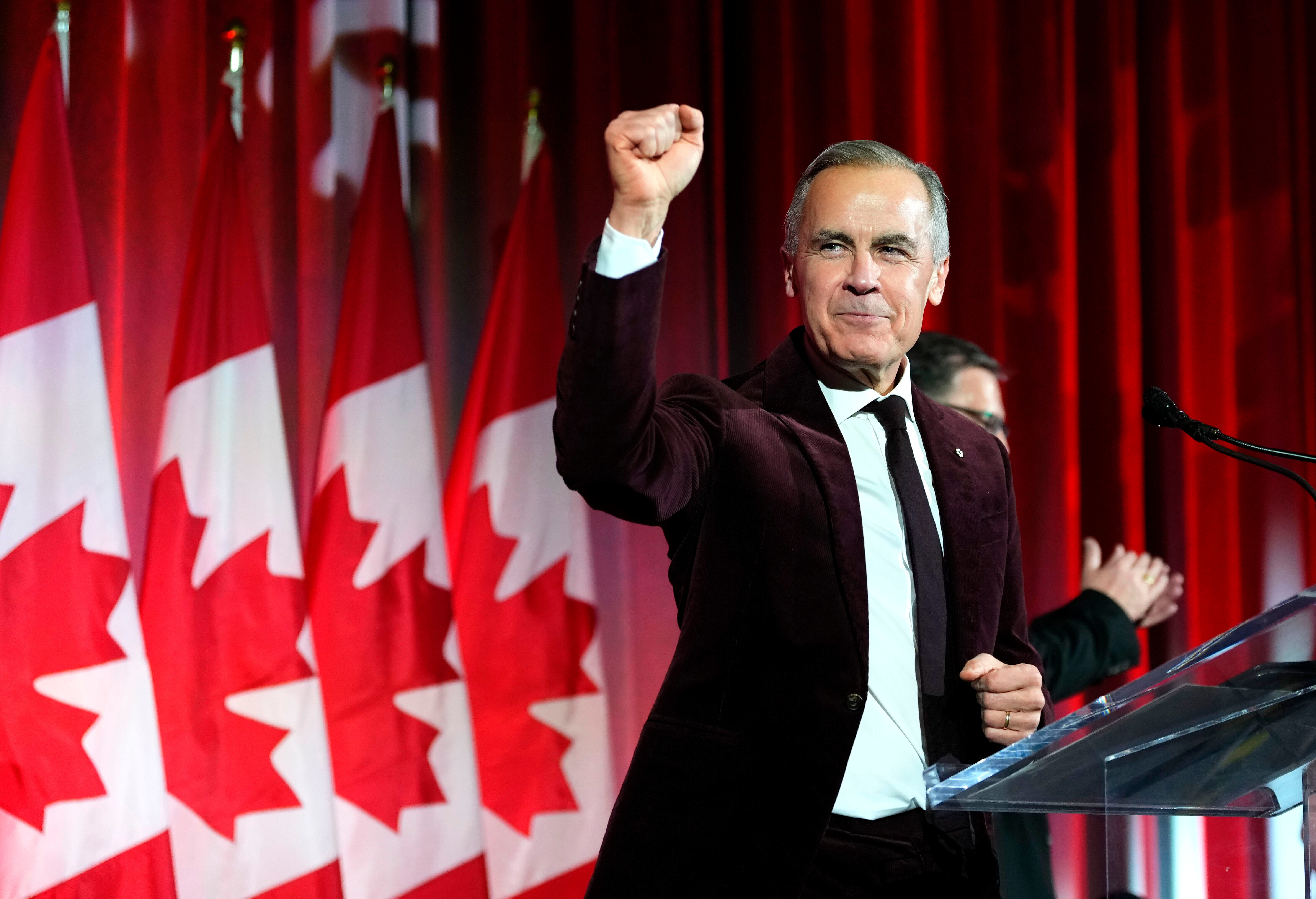 Canada's Prime Minister Mark Carney pumps his fist as he arrives to deliver remarks at the Liberal caucus holiday party in Ottawa, Dec. 11, 2025.