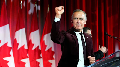 Canada's Prime Minister Mark Carney pumps his fist as he arrives to deliver remarks at the Liberal caucus holiday party in Ottawa, Dec. 11, 2025.
