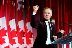 Canada's Prime Minister Mark Carney pumps his fist as he arrives to deliver remarks at the Liberal caucus holiday party in Ottawa, Dec. 11, 2025.