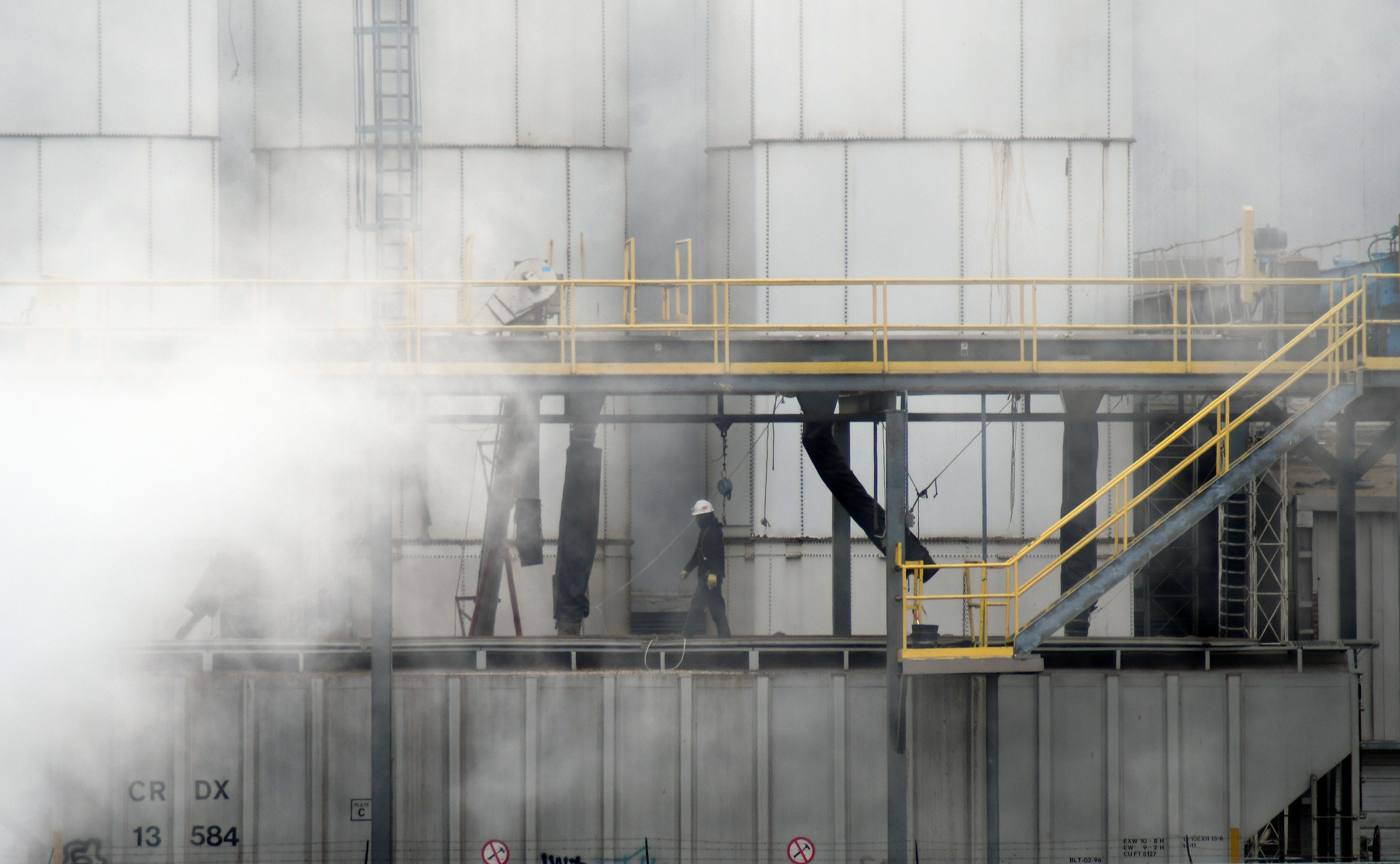 A worker walks through steam coming from the Tyson Foods' beef plant in Lexington, Neb., Thursday, Dec. 4, 2025.