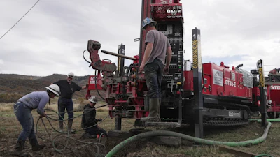 Matt Cooper and his kids Anna, Nathan and Matthew prepare to drill a hole for a geothermal heat pump installation Thursday, Oct. 9, 2025, in Hamilton, Colo.