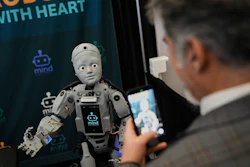 A man records a humanoid robot inside the exhibition room at the Humanoids Summit, Thursday, Dec. 11, 2025, in Mountain View, Calif.