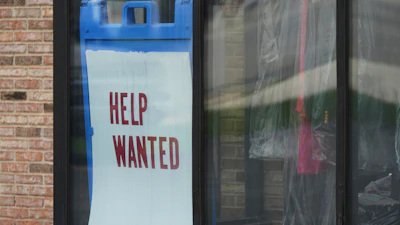 'Help Wanted' sign is displayed at a dry cleaner in Rolling Meadows, Ill., Thursday, May 15, 2025.