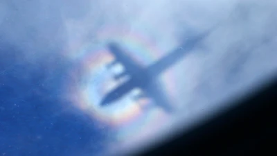 The shadow of a Royal New Zealand Air Force P3 Orion is seen on low level cloud while the aircraft searches for missing Malaysia Airlines Flight MH370 in the southern Indian Ocean, near the coast of Western Australia, March 31, 2014.