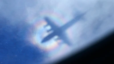 The shadow of a Royal New Zealand Air Force P3 Orion is seen on low level cloud while the aircraft searches for missing Malaysia Airlines Flight MH370 in the southern Indian Ocean, near the coast of Western Australia, March 31, 2014.
