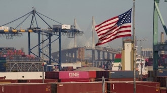 Containers with Yang Ming Marine Transport Corporation, a Taiwanese container shipping company, are stacked up at the Port of Los Angeles with the the Long Beach International Gateway Bridge seen in the background on Wednesday, April 9, 2025 in Los Angeles.