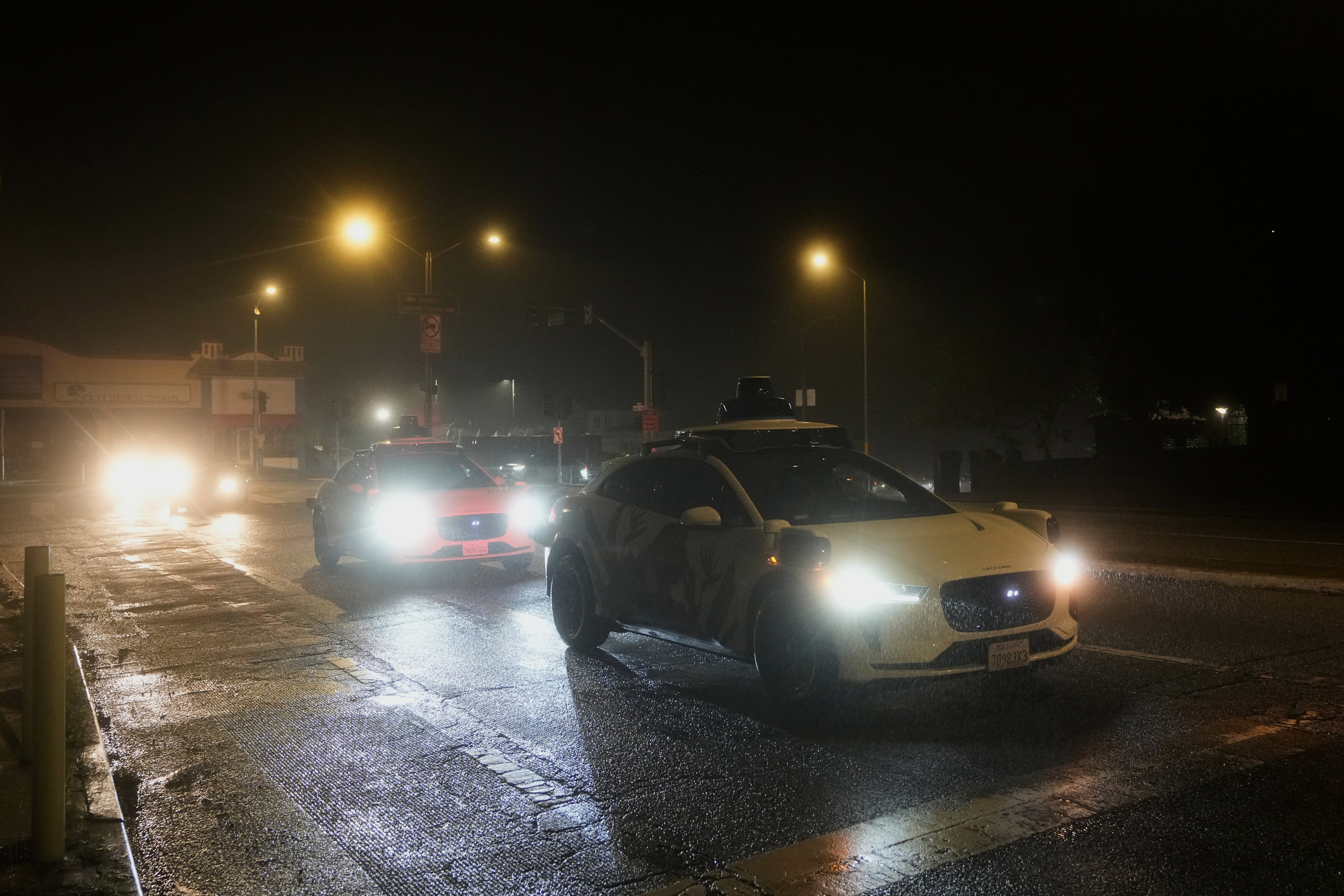 A Waymo vehicle sits idling at an intersection with no operating traffic lights due to power outages, in San Francisco, Saturday, Dec. 20, 2025.