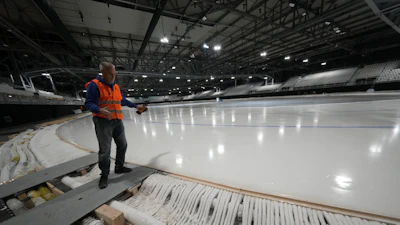 Ice Master Mark Messer poses in the stadium where speed skating discipline of the Milan Cortina 2026 Winter Olympics will take place, in Rho, outskirt of Milan, Tuesday, Nov. 11, 2025.
