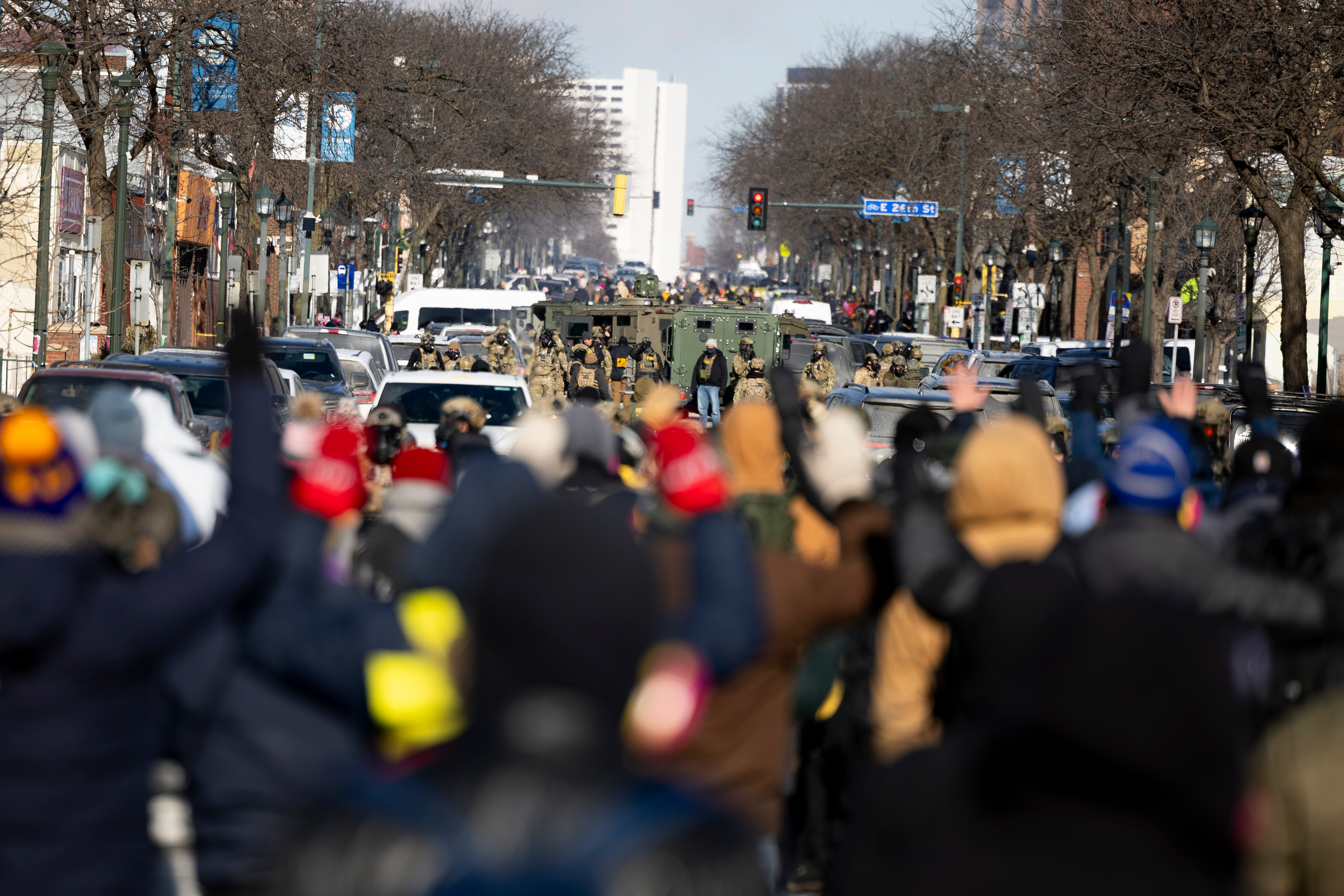 Protesters advance toward federal agents with their hands up near the site of the fatal shooting of 37-year-old Alex Pretti by federal agents in Minneapolis, Jan. 24, 2026.