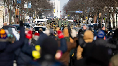 Protesters advance toward federal agents with their hands up near the site of the fatal shooting of 37-year-old Alex Pretti by federal agents in Minneapolis, Jan. 24, 2026.