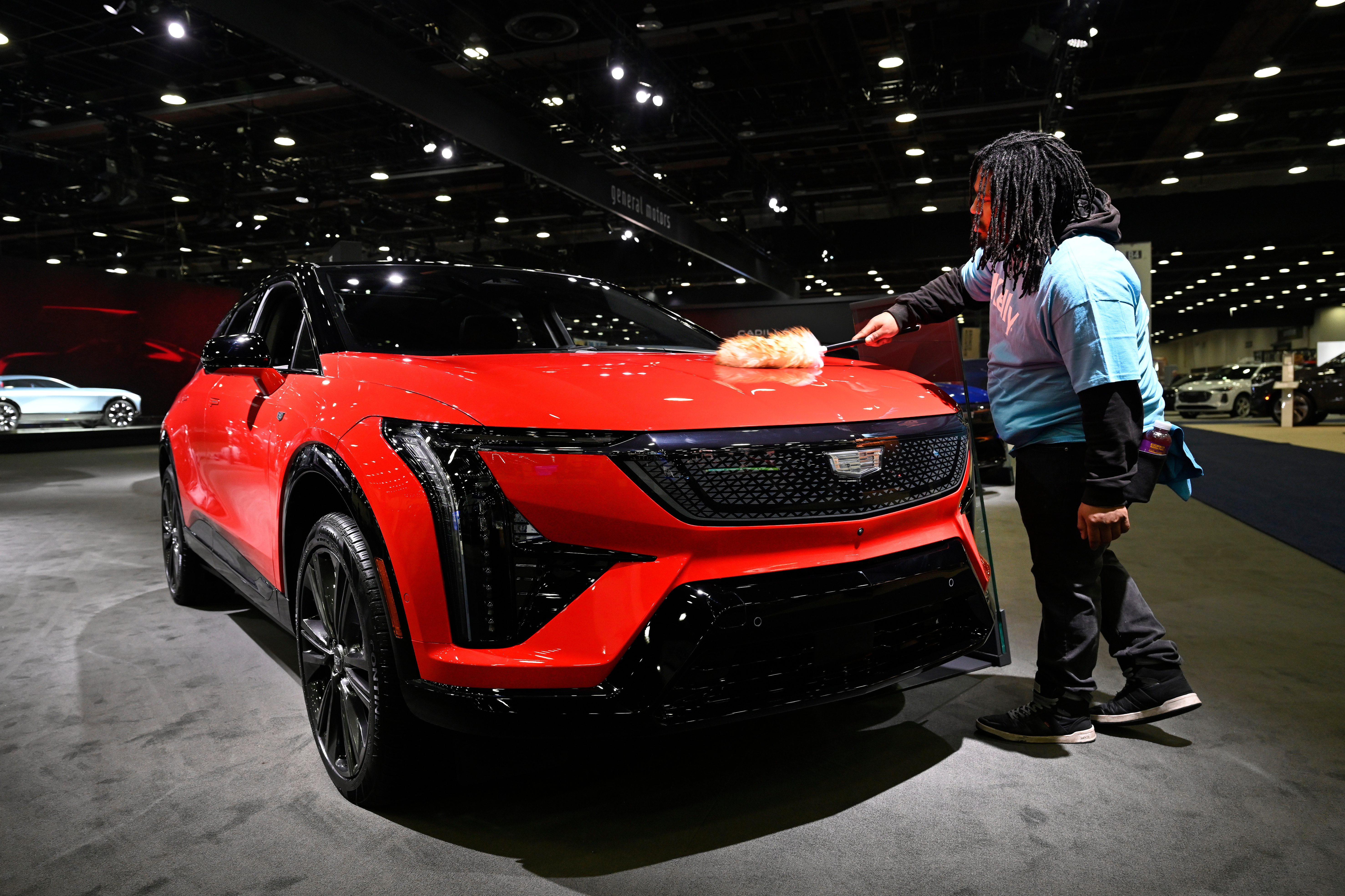 A worker dusts on a 2026 Cadillac Optiq Premium Sport vehicle at the Detroit Auto Show, Wednesday, Jan. 14, 2026, in Detroit.