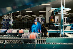 An employee processing fiber at a Corning optical fiber manufacturing facility in Concord, North Carolina.