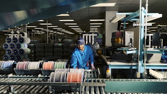 An employee processing fiber at a Corning optical fiber manufacturing facility in Concord, North Carolina.